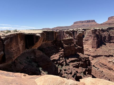 A curving alcove in the rim above Monument Basin, with towers and buttresses stepping down into the basin.