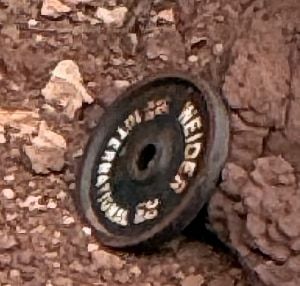 A weightlifting plate at the bottom of Musselman Arch.